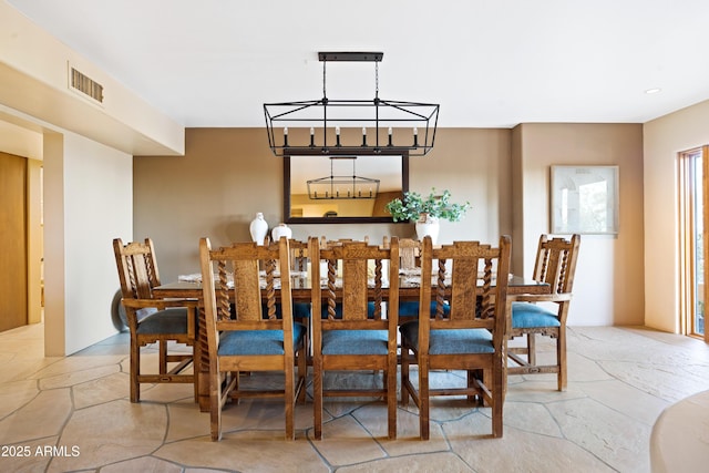 dining room with stone finish flooring and visible vents