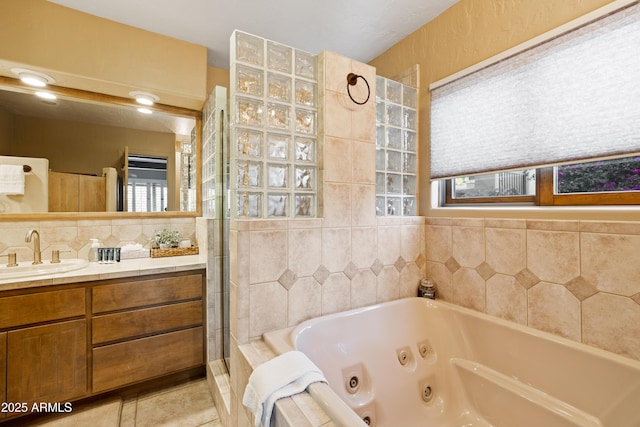 bathroom featuring vanity, a jetted tub, a tile shower, tile patterned floors, and tasteful backsplash