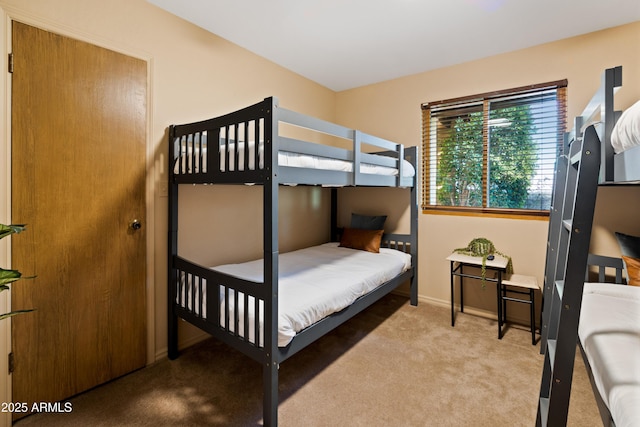 bedroom featuring light carpet and baseboards