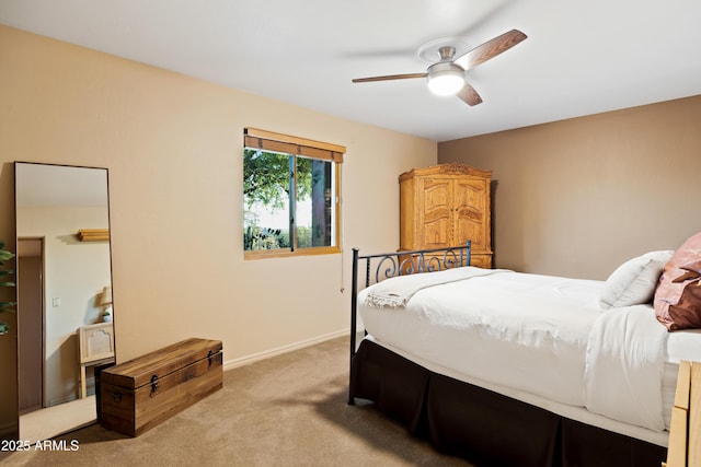 carpeted bedroom featuring ceiling fan and baseboards