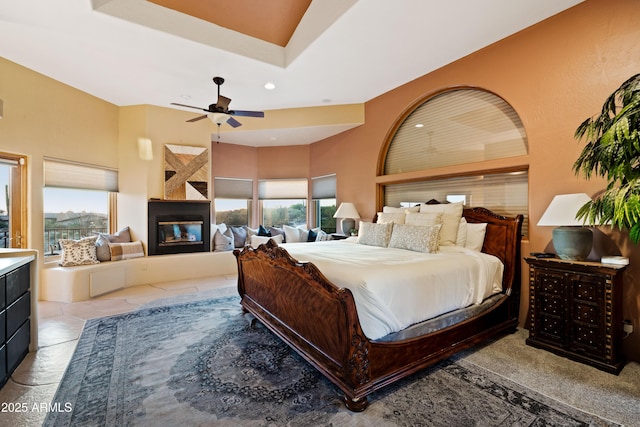 bedroom with a multi sided fireplace and recessed lighting