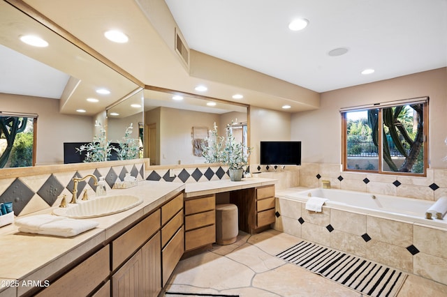 full bath featuring recessed lighting, visible vents, a garden tub, and vanity