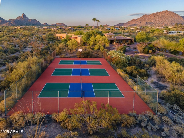 view of sport court featuring fence and a mountain view