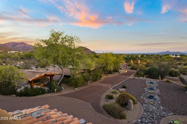 exterior space with decorative driveway and a mountain view