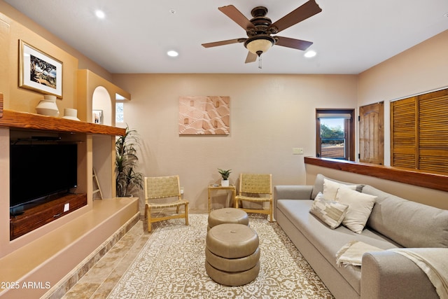 living room featuring a ceiling fan and recessed lighting