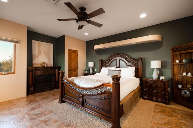 bedroom featuring a ceiling fan, a fireplace, visible vents, and recessed lighting