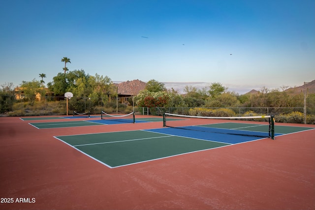 view of sport court featuring community basketball court, fence, and a mountain view