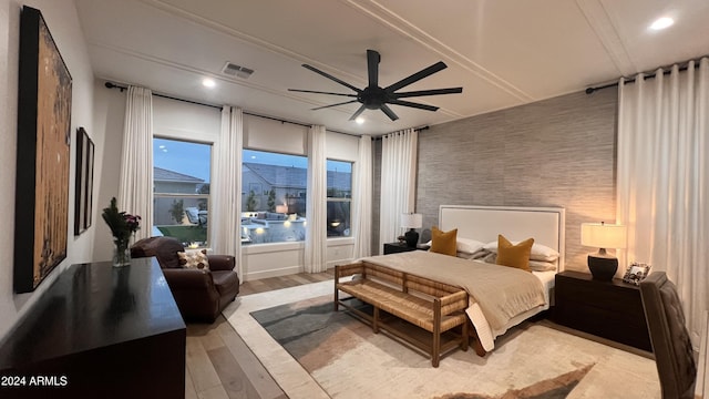 bedroom with ceiling fan and light hardwood / wood-style floors