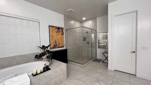 bathroom featuring plus walk in shower and tile patterned floors