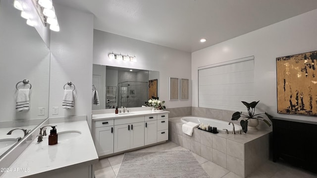 bathroom featuring tile patterned flooring, vanity, and shower with separate bathtub