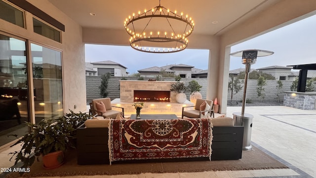 view of patio with an outdoor living space with a fireplace