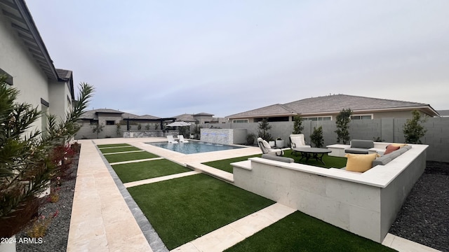 exterior space featuring pool water feature, a fenced in pool, and a patio