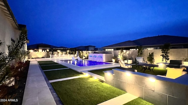 pool at night with pool water feature