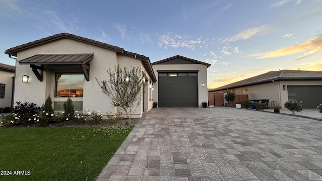 view of front facade with a garage and a lawn