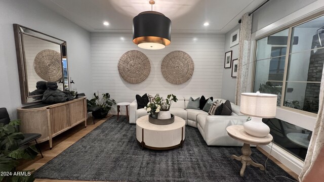 living room featuring wood walls and wood-type flooring