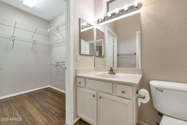 bathroom featuring hardwood / wood-style floors, vanity, and toilet