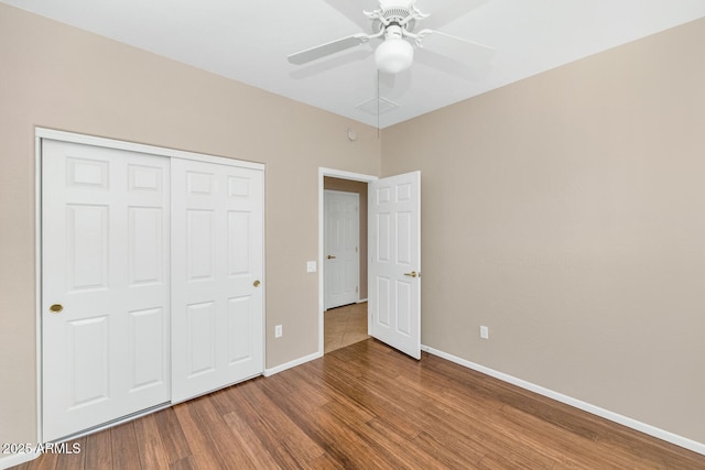 unfurnished bedroom featuring wood-type flooring, a closet, and ceiling fan