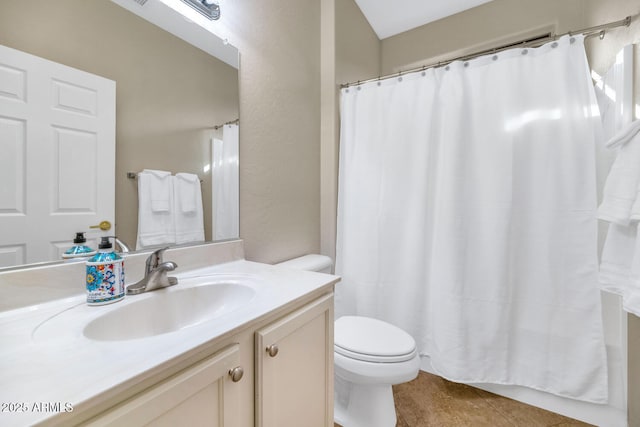 bathroom with tile patterned flooring, vanity, and toilet