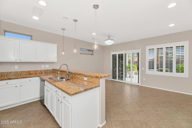 kitchen featuring white cabinetry, sink, kitchen peninsula, and hanging light fixtures