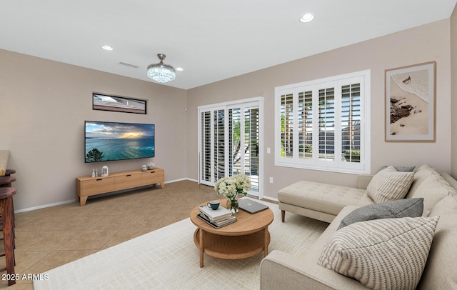 living room with light tile patterned flooring and a chandelier