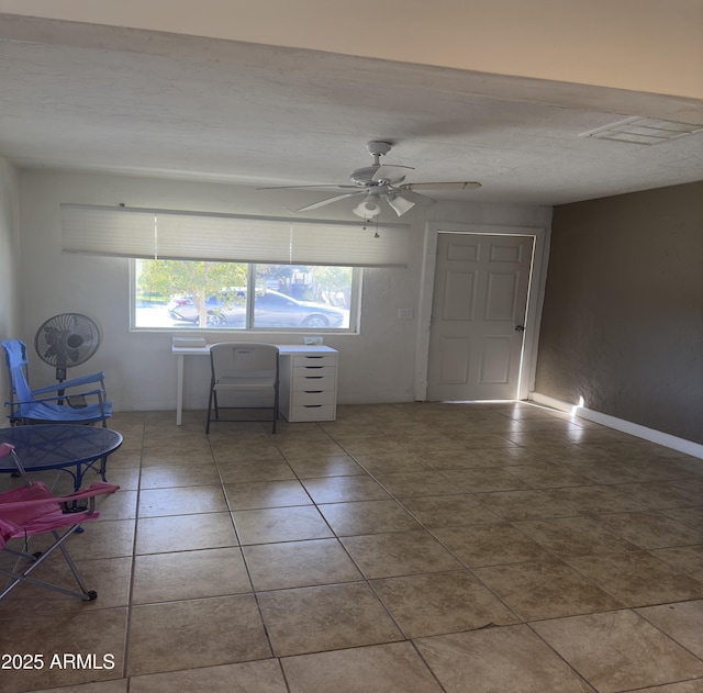 tiled spare room with ceiling fan, a textured ceiling, and visible vents