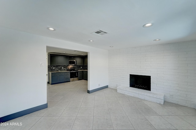 unfurnished living room featuring a fireplace and light tile patterned floors