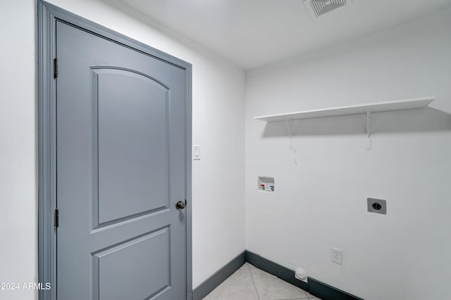 clothes washing area featuring washer hookup, light tile patterned floors, and electric dryer hookup