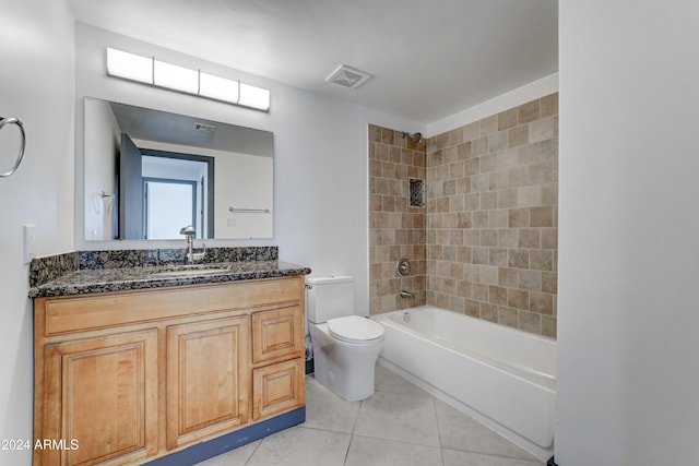 full bathroom with toilet, vanity, tiled shower / bath combo, and tile patterned floors