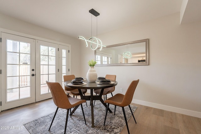 1301 N 44th St, Phoenix, AZ 85008 - dining room with baseboards, french doors, light wood-style floors, and a chandelier
