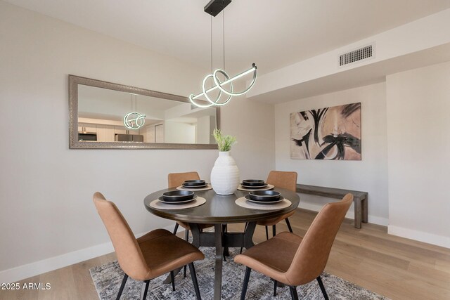 1301 N 44th St, Phoenix, AZ 85008 - dining space featuring baseboards and wood finished floors