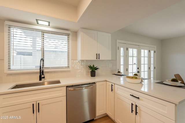 1301 N 44th St, Phoenix, AZ 85008 - kitchen with stainless steel dishwasher, a sink, a peninsula, and light countertops