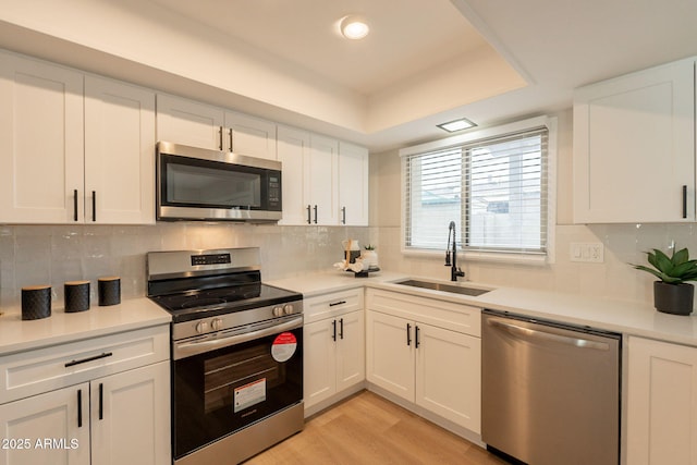 1301 N 44th St, Phoenix, AZ 85008 - kitchen with stainless steel appliances, a sink, white cabinetry, and light countertops