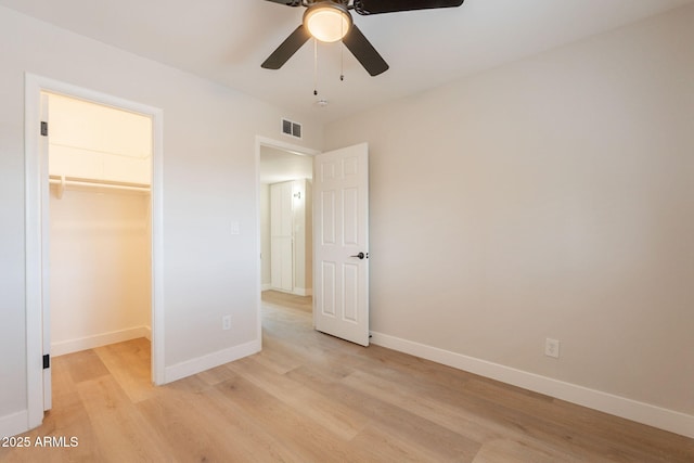 1301 N 44th St, Phoenix, AZ 85008 - unfurnished bedroom with light wood finished floors, a spacious closet, baseboards, and a closet