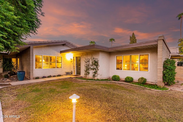 view of front of home with a lawn