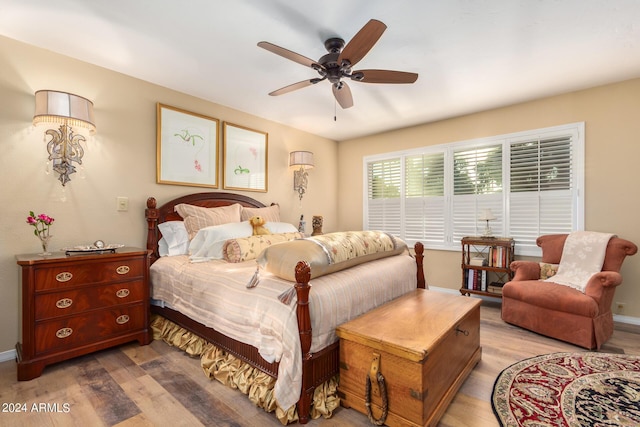 bedroom with ceiling fan and light hardwood / wood-style flooring