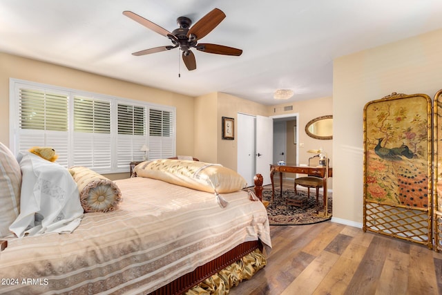 bedroom with ceiling fan and hardwood / wood-style floors