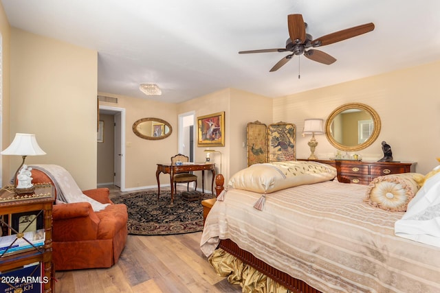 bedroom with light hardwood / wood-style flooring and ceiling fan