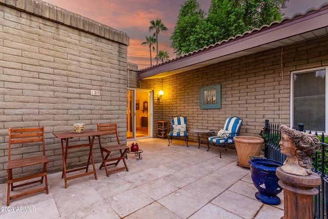 view of patio terrace at dusk