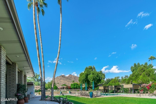 view of yard with a fenced in pool and a mountain view