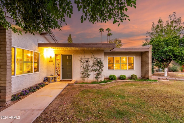 view of front of home with a yard