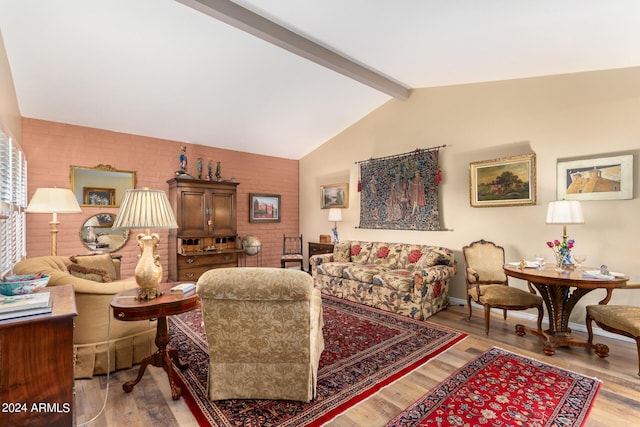 living room featuring hardwood / wood-style flooring, brick wall, and vaulted ceiling with beams