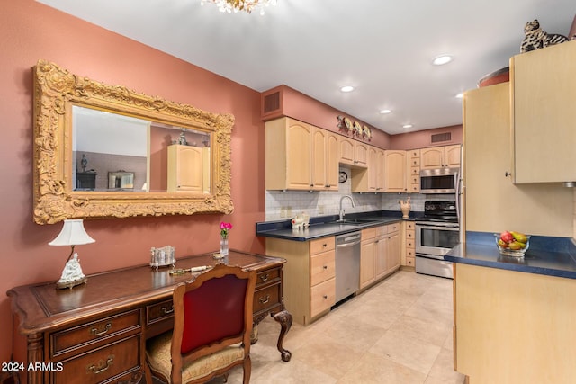 kitchen with tasteful backsplash, sink, light brown cabinets, and appliances with stainless steel finishes