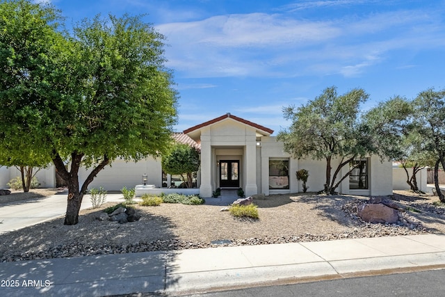 10013 N 106th Pl, Scottsdale, AZ 85258 - view of front of property with stucco siding, an attached garage, and concrete driveway