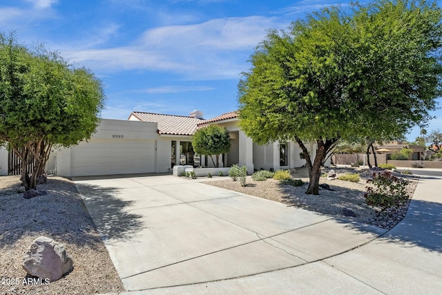 10013 N 106th Pl, Scottsdale, AZ 85258 - view of front of house with stucco siding, concrete driveway, an attached garage, and a tiled roof