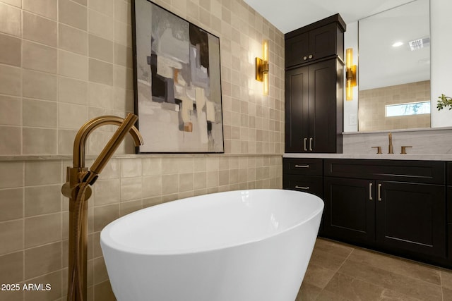 10013 N 106th Pl, Scottsdale, AZ 85258 - bathroom featuring visible vents, tile walls, and a freestanding tub