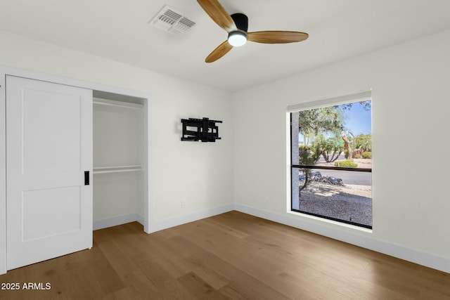 10013 N 106th Pl, Scottsdale, AZ 85258 - unfurnished bedroom with wood finished floors, visible vents, baseboards, ceiling fan, and a closet