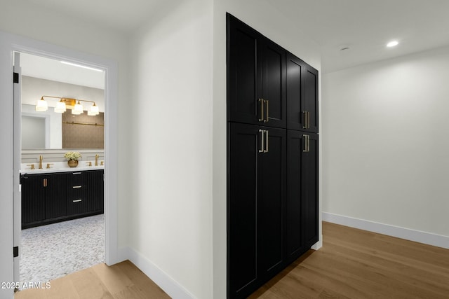 10013 N 106th Pl, Scottsdale, AZ 85258 - hall featuring light wood finished floors, recessed lighting, baseboards, and a sink