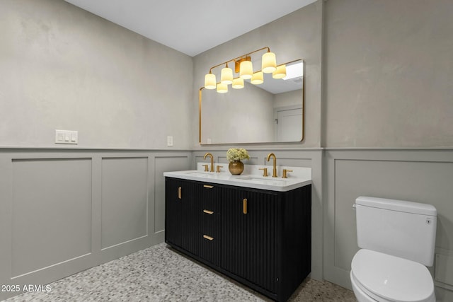 10013 N 106th Pl, Scottsdale, AZ 85258 - full bathroom featuring a sink, a wainscoted wall, and toilet