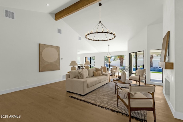 10013 N 106th Pl, Scottsdale, AZ 85258 - living room with visible vents, beamed ceiling, light wood-style flooring, and an inviting chandelier