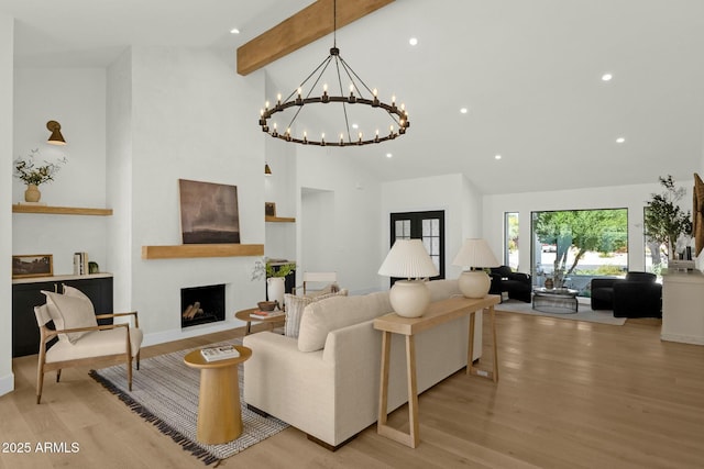 10013 N 106th Pl, Scottsdale, AZ 85258 - living area featuring high vaulted ceiling, light wood-style flooring, recessed lighting, a fireplace with raised hearth, and beamed ceiling